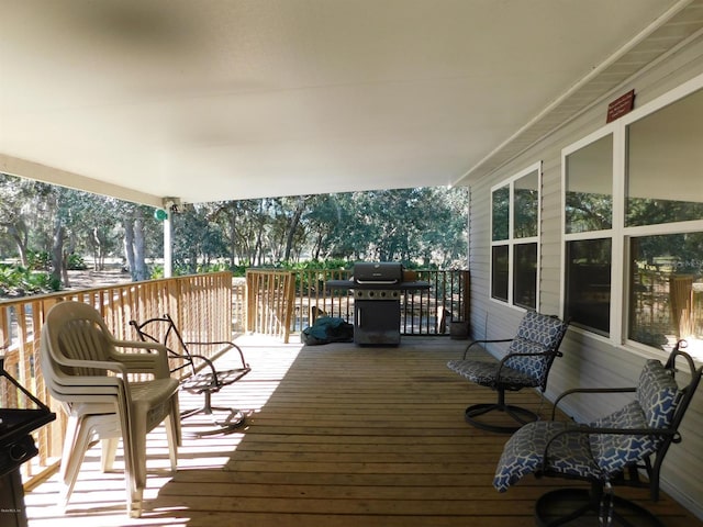 wooden terrace featuring a grill