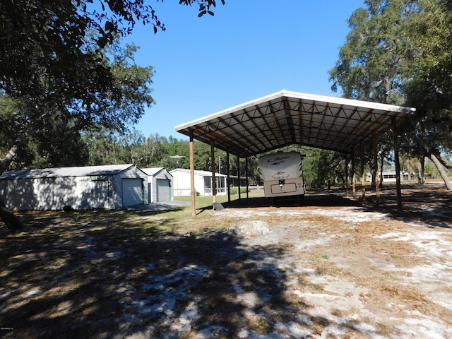 view of yard featuring an outdoor structure and a carport