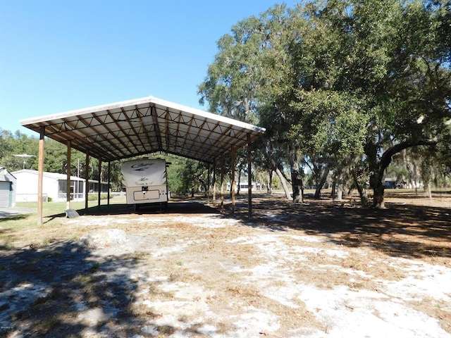 view of vehicle parking with a carport