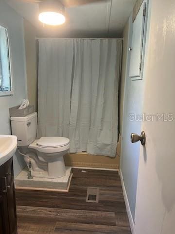 bathroom with hardwood / wood-style floors, vanity, and toilet