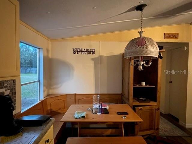 dining area featuring a wealth of natural light and vaulted ceiling