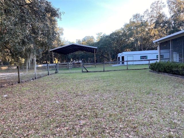 view of yard featuring a carport and fence