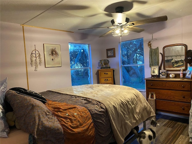 bedroom with ceiling fan and dark hardwood / wood-style floors