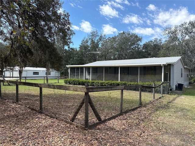 view of front of property with fence and metal roof