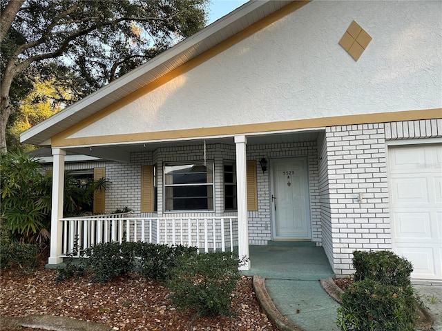 exterior space with a porch and a garage