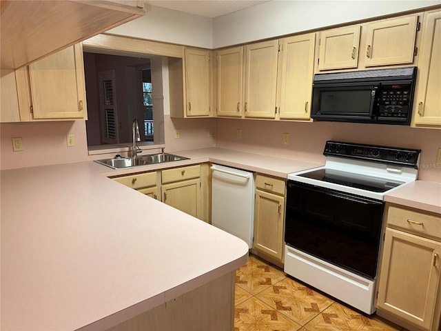 kitchen featuring light brown cabinetry, white appliances, and sink