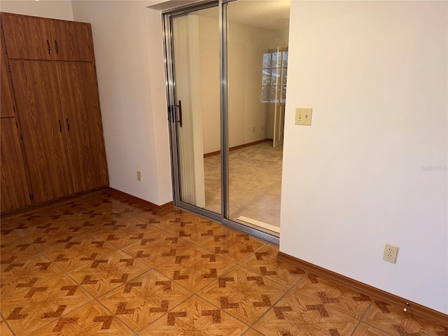 unfurnished bedroom with light parquet floors and a closet