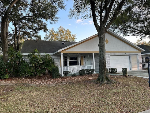 ranch-style house featuring a porch and a garage