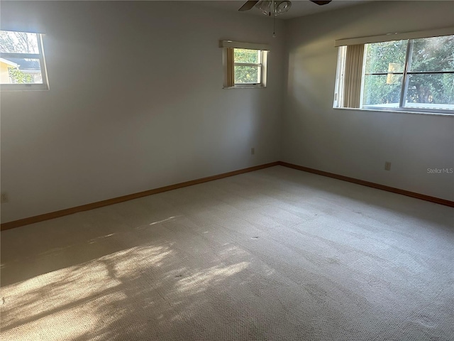 unfurnished room with carpet floors and ceiling fan