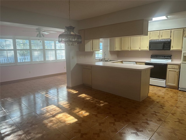 kitchen featuring sink, kitchen peninsula, hanging light fixtures, ceiling fan, and range