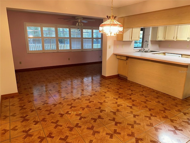 kitchen with ceiling fan, sink, light tile patterned floors, and pendant lighting