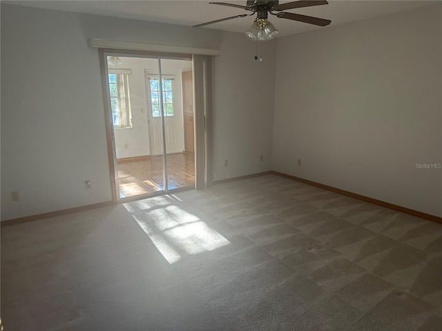 unfurnished room featuring ceiling fan and light carpet