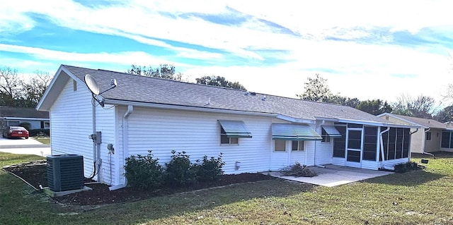 back of house featuring cooling unit, a yard, and a patio