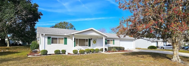 ranch-style home featuring a garage and a front yard