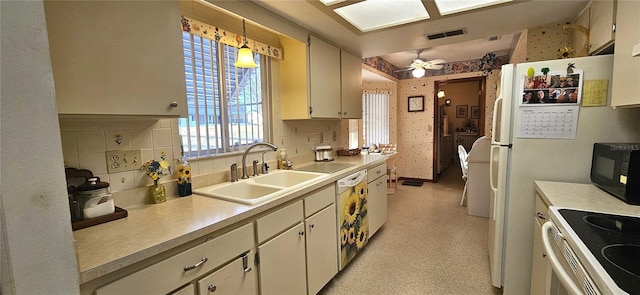 kitchen with pendant lighting, white appliances, sink, ceiling fan, and tasteful backsplash