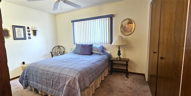 bedroom featuring ceiling fan, light colored carpet, and a textured ceiling