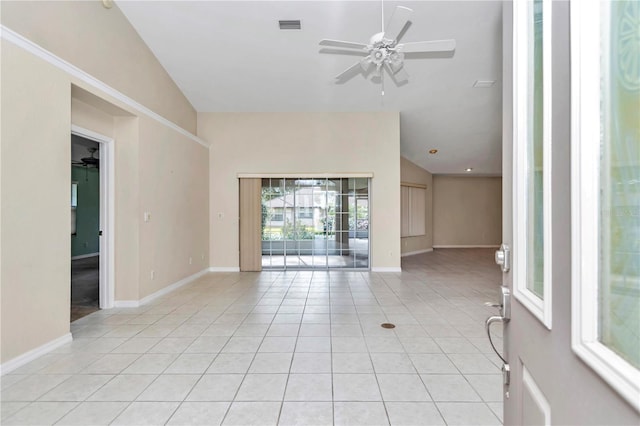 tiled empty room featuring ceiling fan and vaulted ceiling