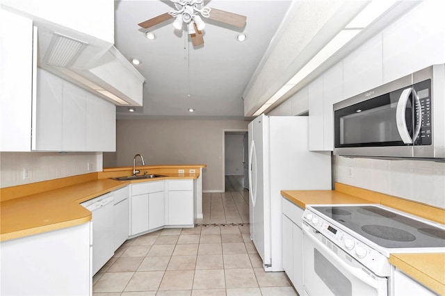 kitchen with white appliances, ceiling fan, sink, light tile patterned floors, and white cabinets