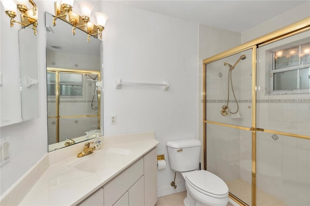 bathroom with a shower with door, vanity, and toilet