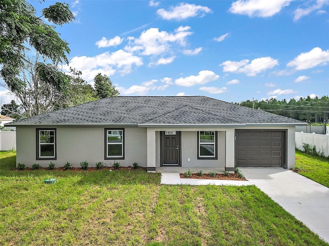 single story home featuring a garage and a front yard