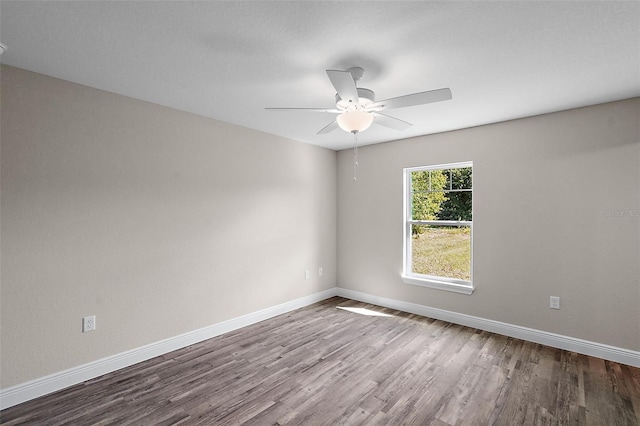 empty room featuring ceiling fan and hardwood / wood-style floors