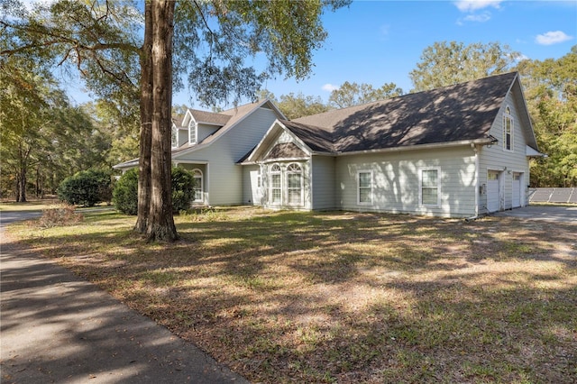 view of front of property with a front lawn and a garage