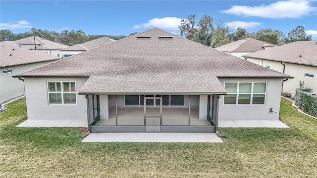 rear view of property with a sunroom and a lawn