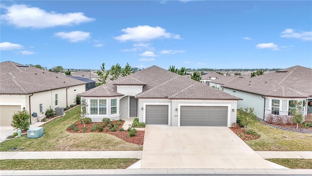 view of front of home featuring cooling unit, a garage, and a front yard