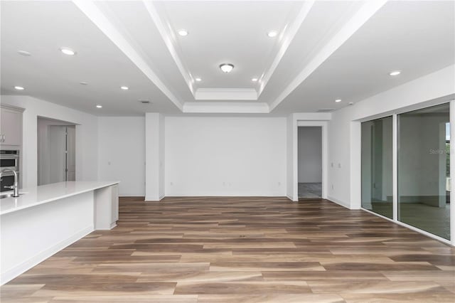 interior space featuring hardwood / wood-style flooring, ornamental molding, and sink