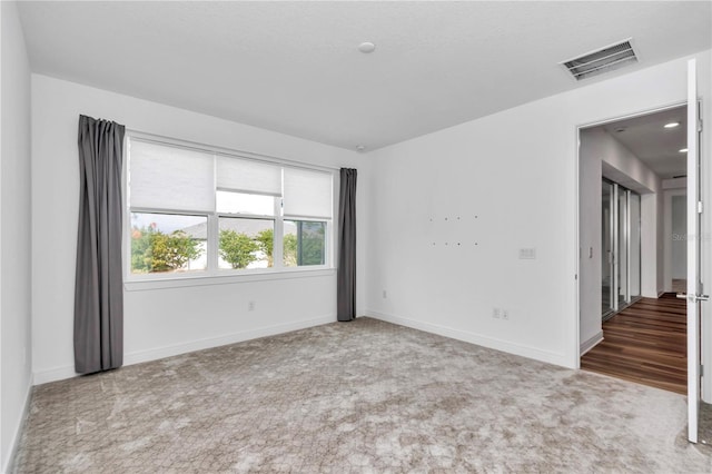 unfurnished room featuring carpet flooring