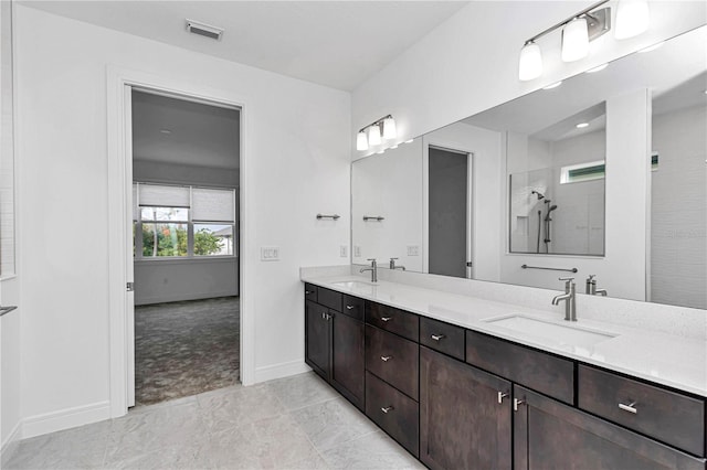 bathroom featuring a shower and vanity