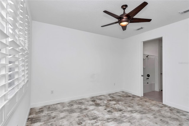 empty room featuring ceiling fan and light colored carpet