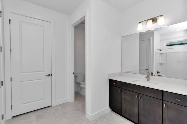 bathroom featuring vanity and toilet