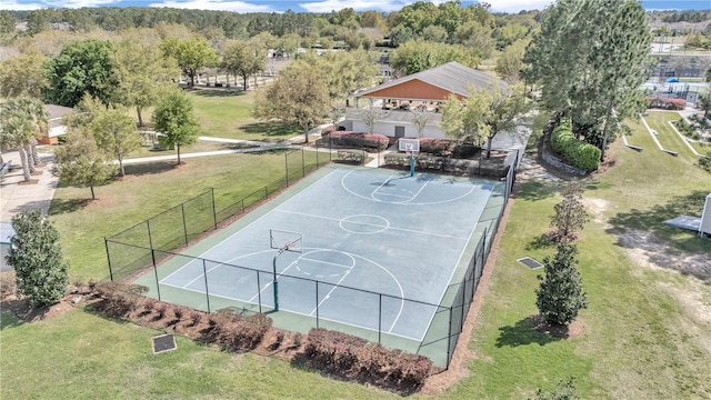 view of basketball court with a yard