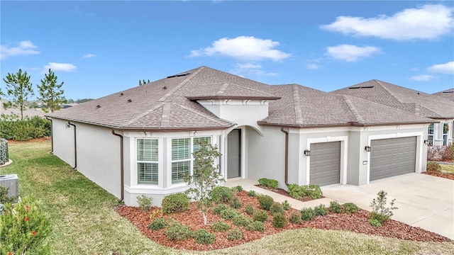 view of front of property with a front yard and a garage