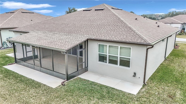 rear view of property featuring a lawn and a sunroom