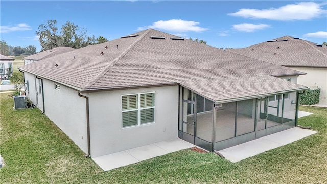 back of house with a yard, cooling unit, and a sunroom