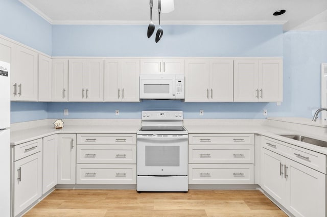 kitchen featuring white cabinets, white appliances, and sink