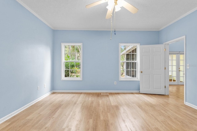 spare room featuring ceiling fan, light hardwood / wood-style floors, a textured ceiling, and ornamental molding