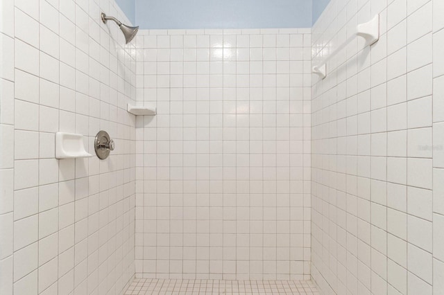 bathroom with tiled shower