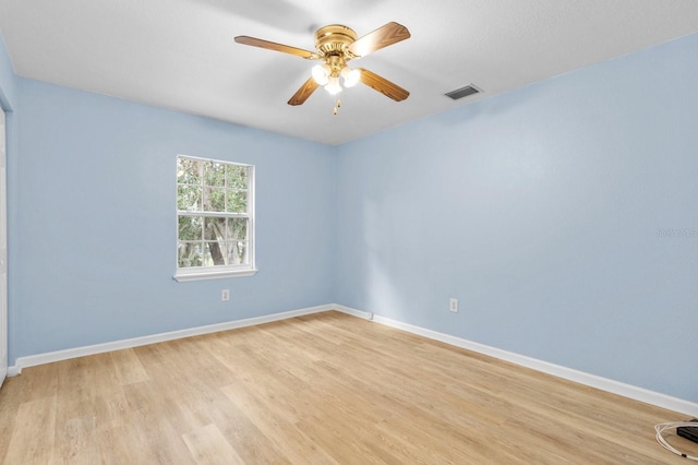 spare room with ceiling fan and light wood-type flooring