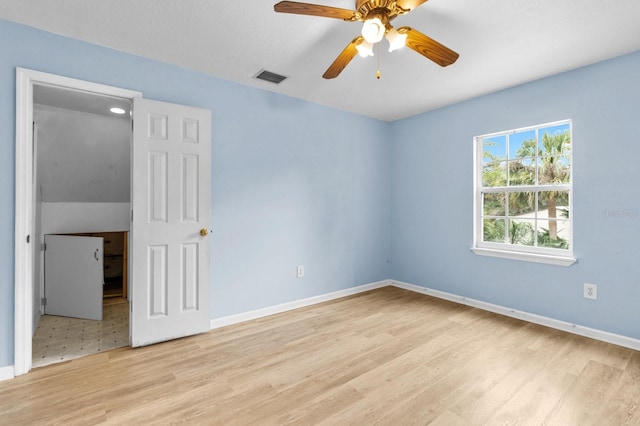 unfurnished room with ceiling fan and light hardwood / wood-style floors