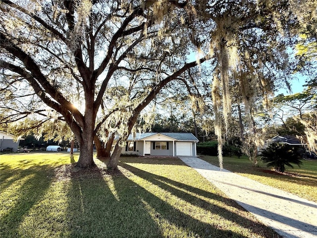 ranch-style home featuring a garage and a front yard