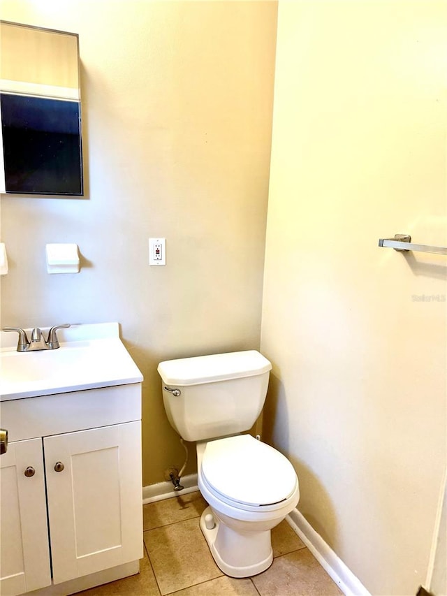 bathroom featuring tile patterned flooring, vanity, and toilet