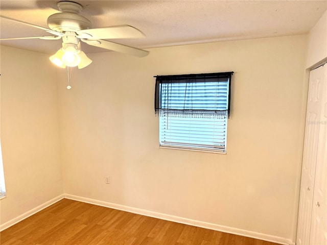 unfurnished room with hardwood / wood-style flooring and ceiling fan