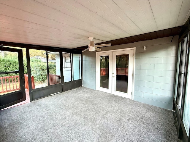 unfurnished sunroom featuring french doors and ceiling fan