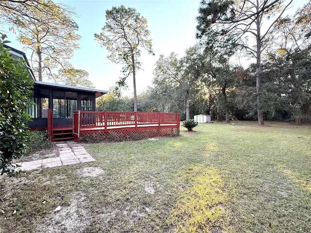 view of yard with a deck, a storage unit, and a sunroom