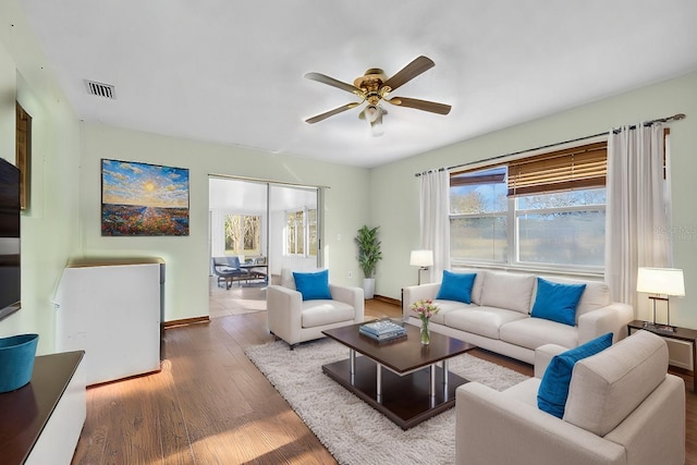 living room featuring ceiling fan and hardwood / wood-style flooring