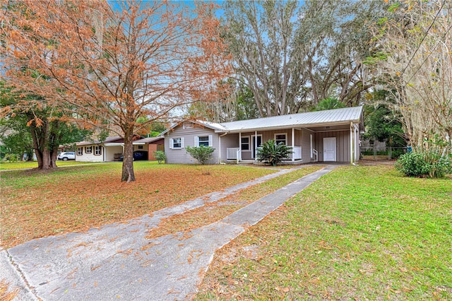 ranch-style house featuring a front yard, a porch, and a carport