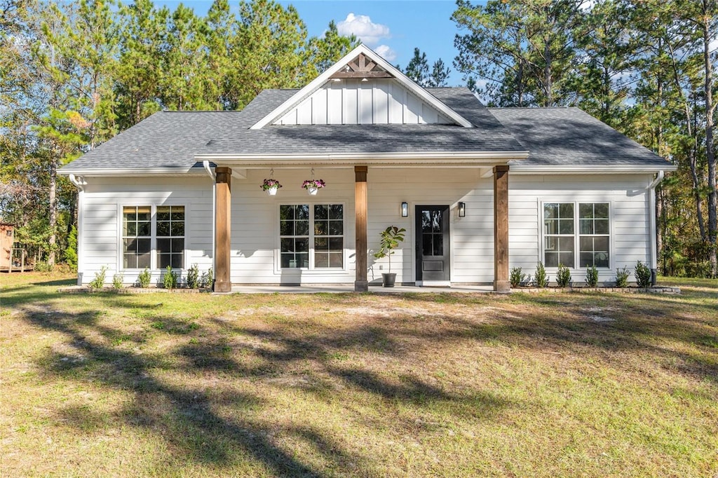 view of front of house with covered porch and a front yard